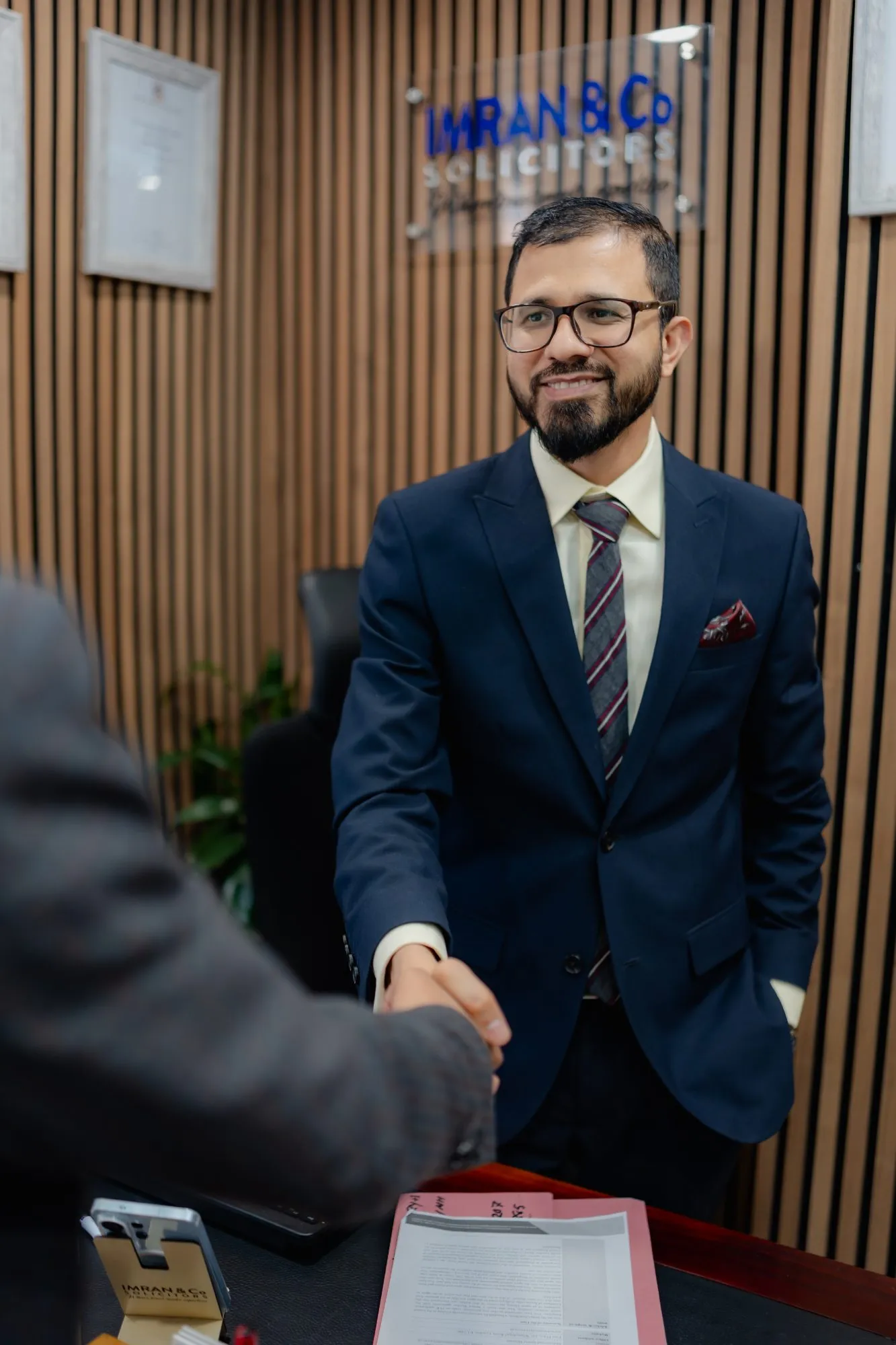 Principal Solicitor greeting a client in the Imran & Co reception