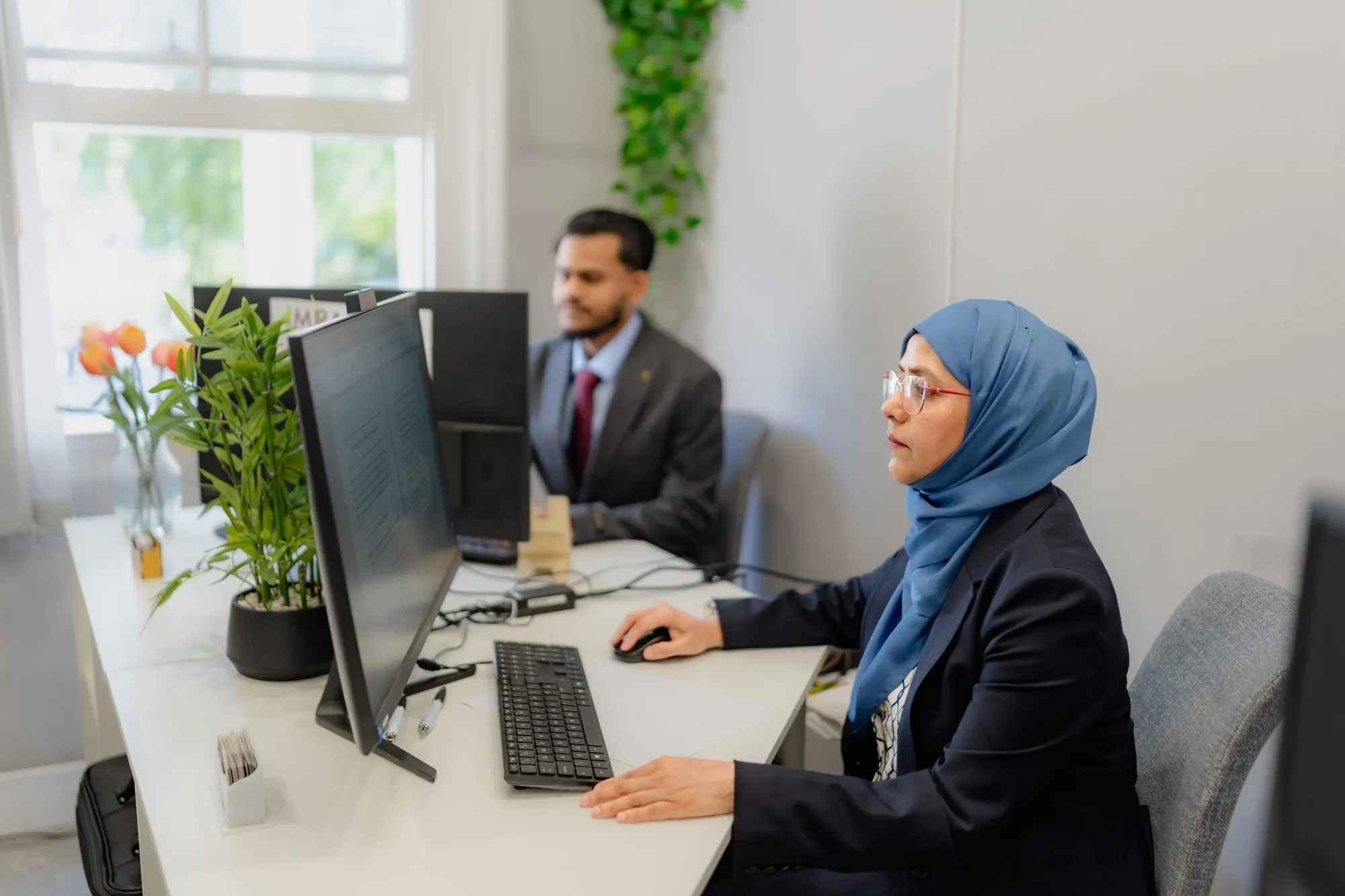 Two members of the team reviewing a client file together